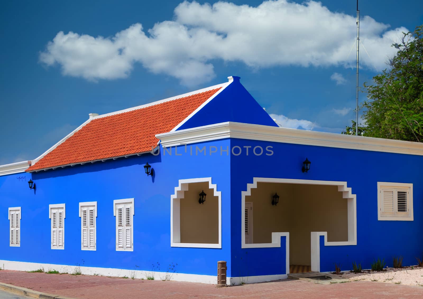 Blue Plaster Building with Orange Roof by dbvirago
