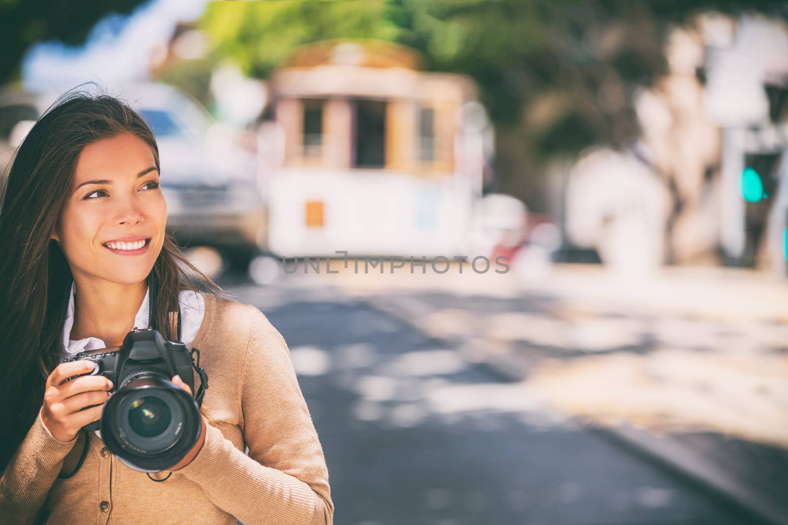 Photographer woman Asian girl taking photos with slr camera professional photography looking at San Francisco cable car tramway. Tourist taking pictures of popular attraction California, USA travel by Maridav