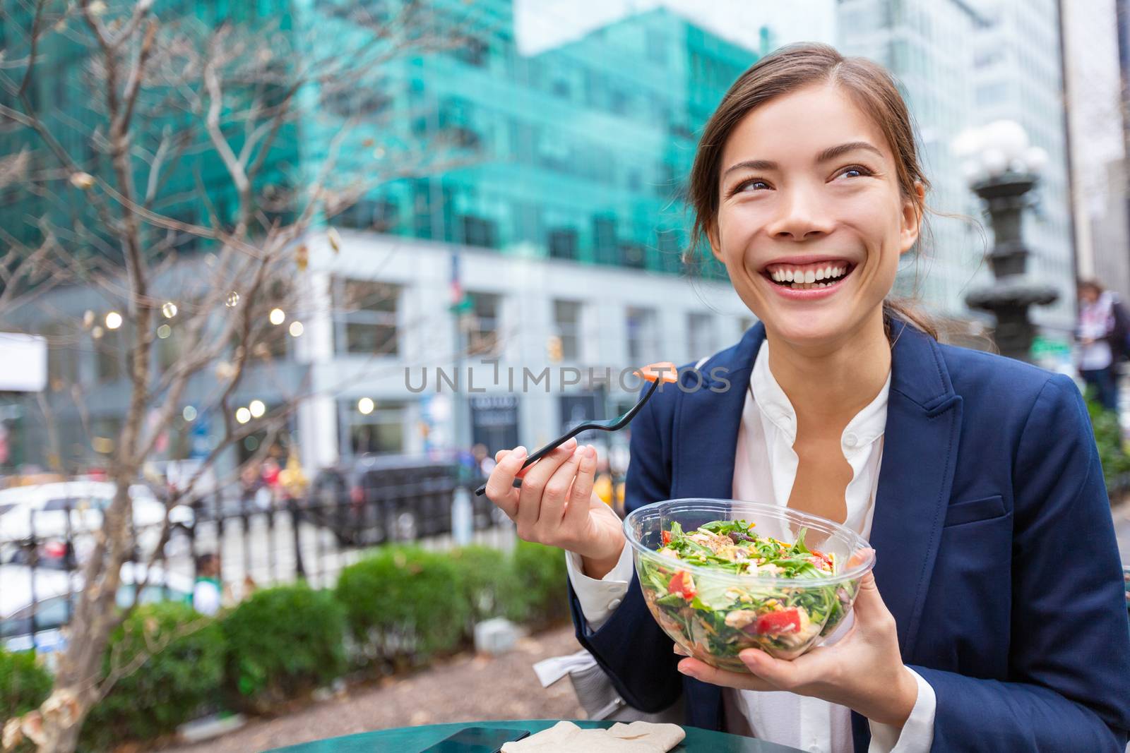 Lunch salad take out bowl healthy eating Asian business woman ready to eat in City Park living lifestyle . Happy smiling multiracial chinese young businesswoman, New York City, USA.