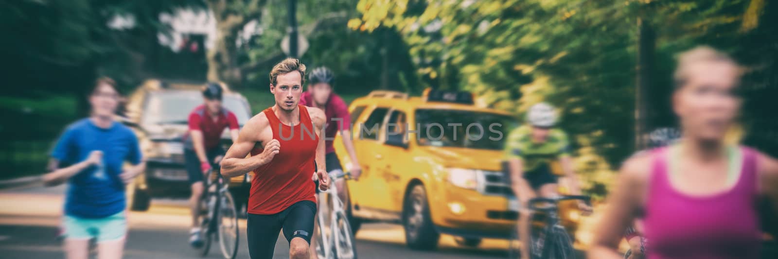 Fit runners motion blur people crowd training in city panorama banner - Athletes jogging, biking in New York city with yellow cabs cars background. Man running fast in blurred motion.