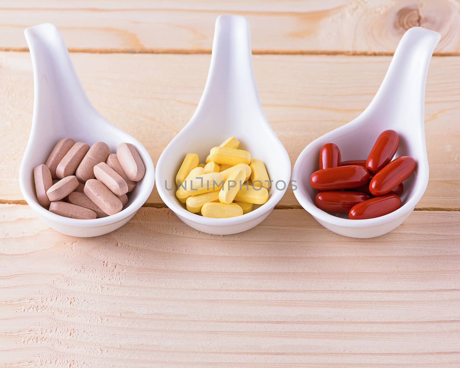 Vitamin pill on wood table, healthy concept