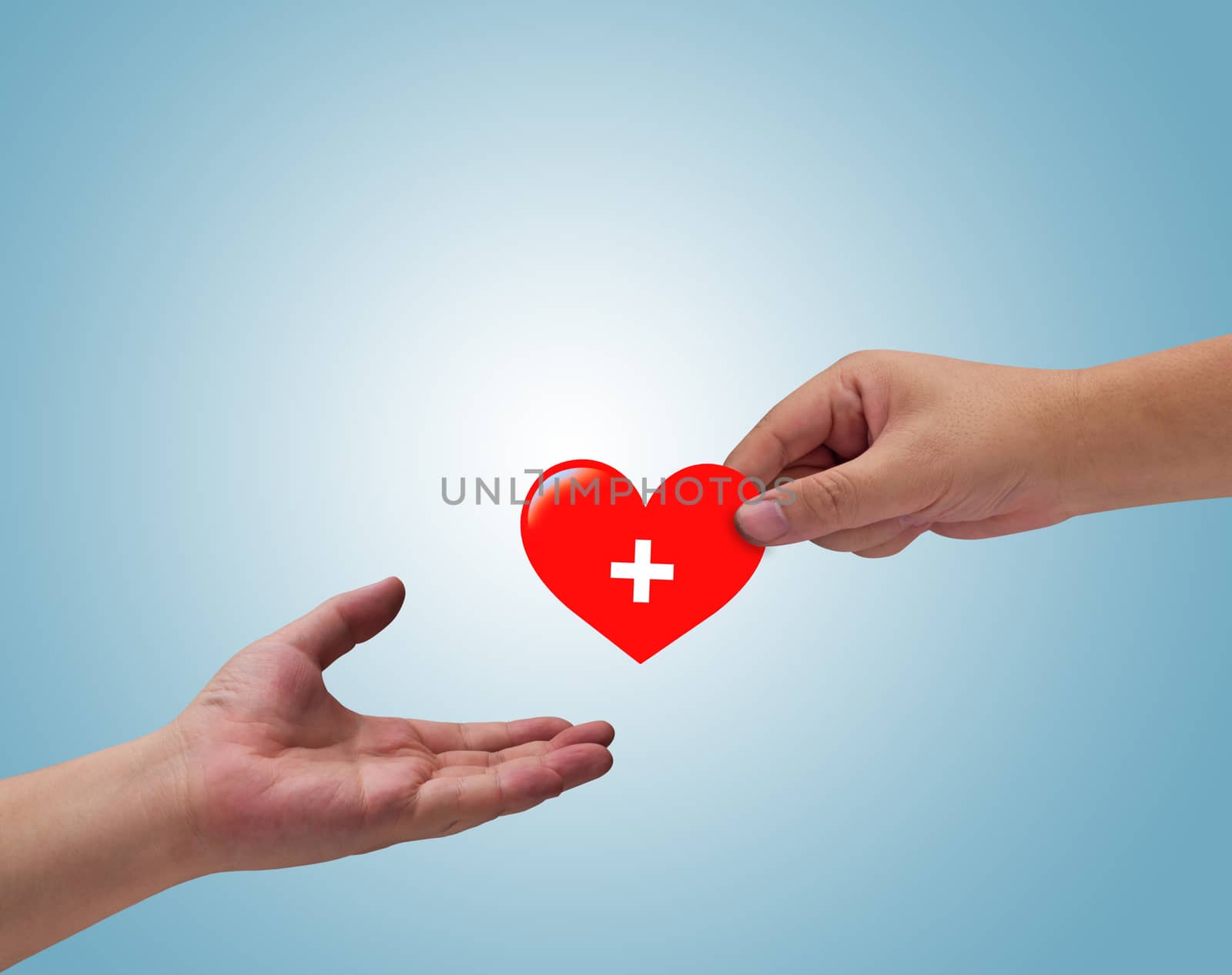 Health care and insurance concept, hand and red heart paper cut on blue background
