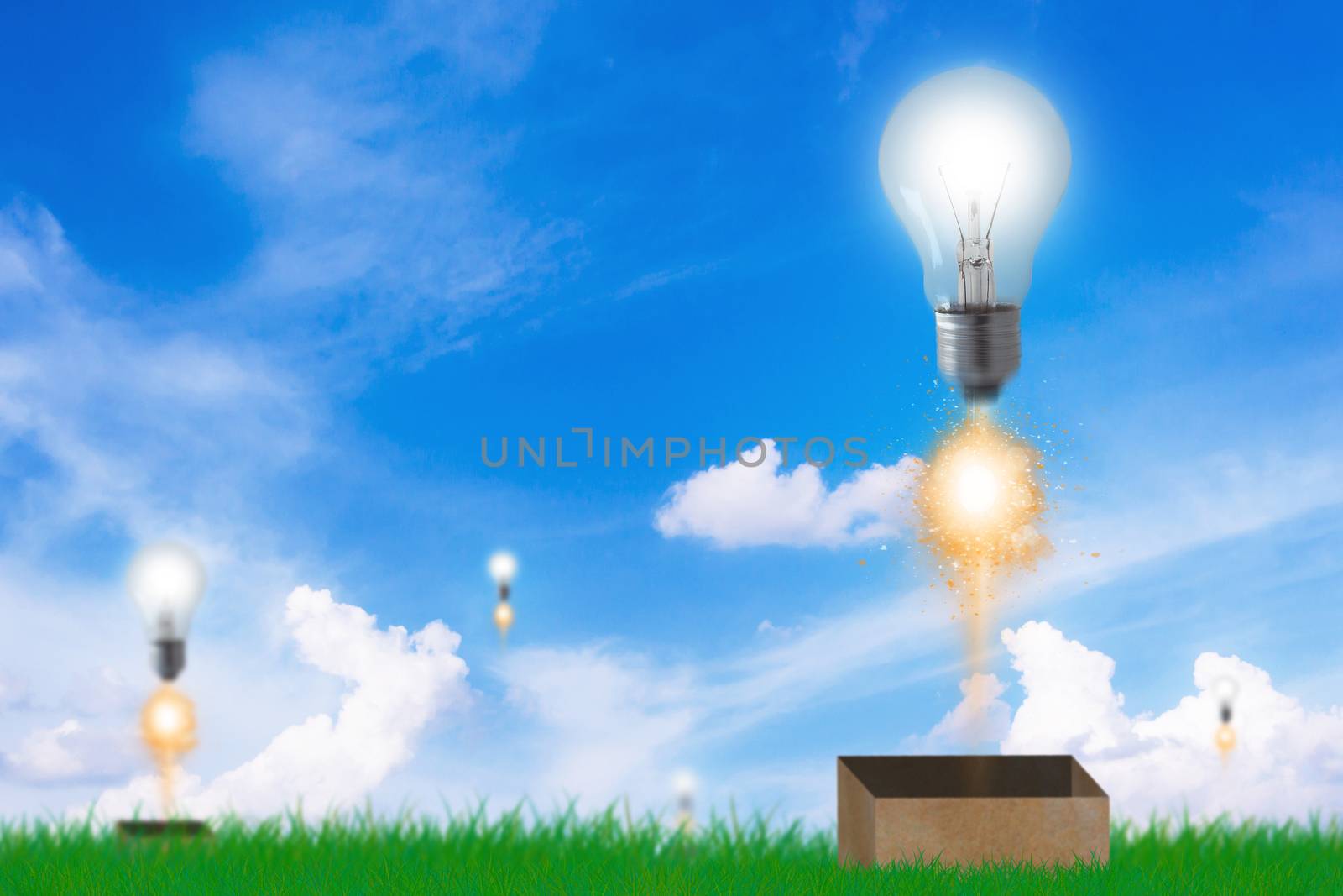 Think outside the box concept, light bulb flying on blue sky background, idea and inspiration 