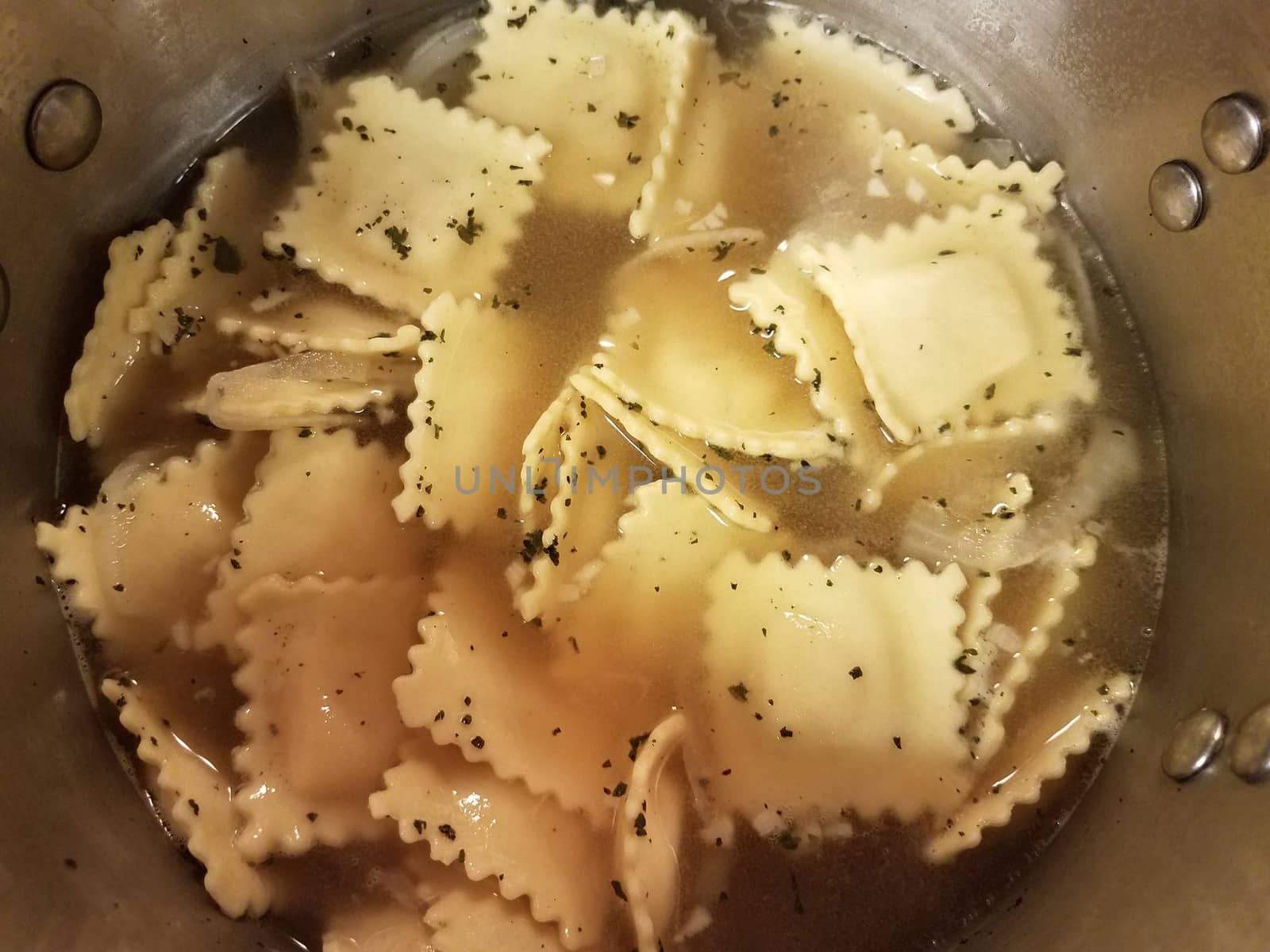 pot of boiling water with ravioli pasta cooking