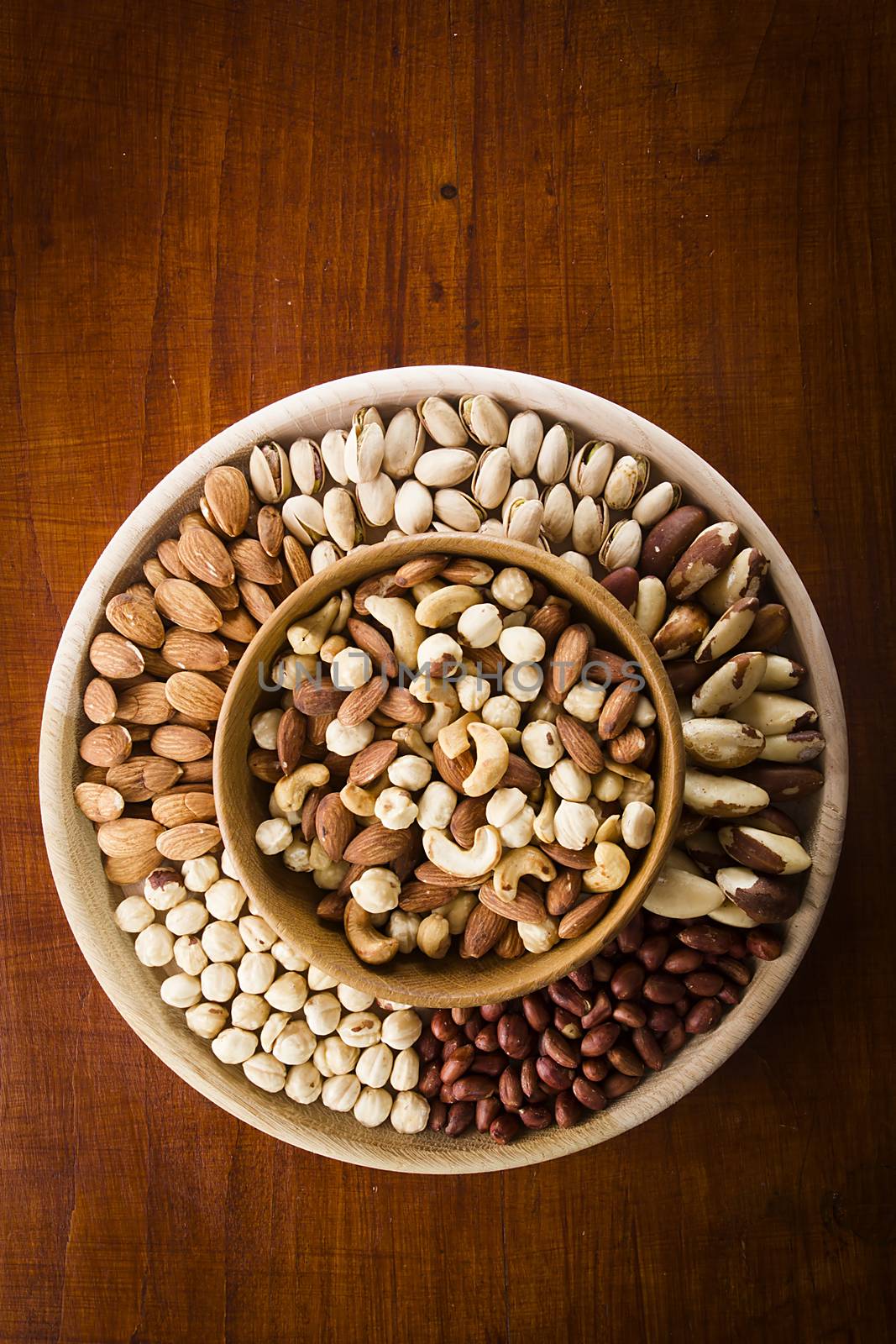 Set of various nuts in a wooden bowl
