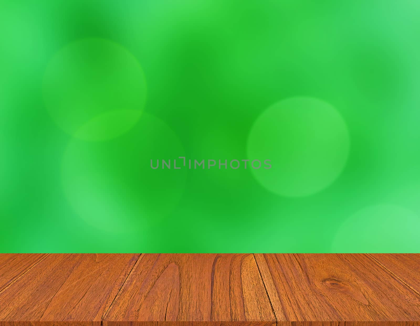 Wood table on green blur bokeh background, montage or display product concept