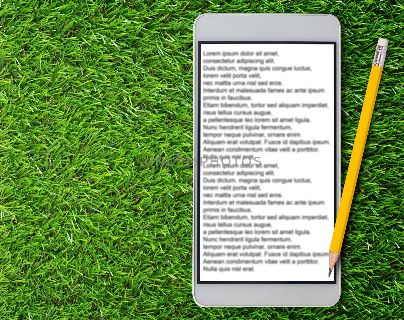 E-book, Electronic reading concept, internet content service, mobile phone and yellow pencil on green grass background