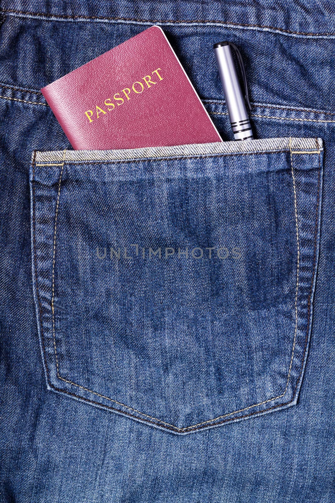 Passport and pen in blue jean pocket, traveling concept, tourism concept