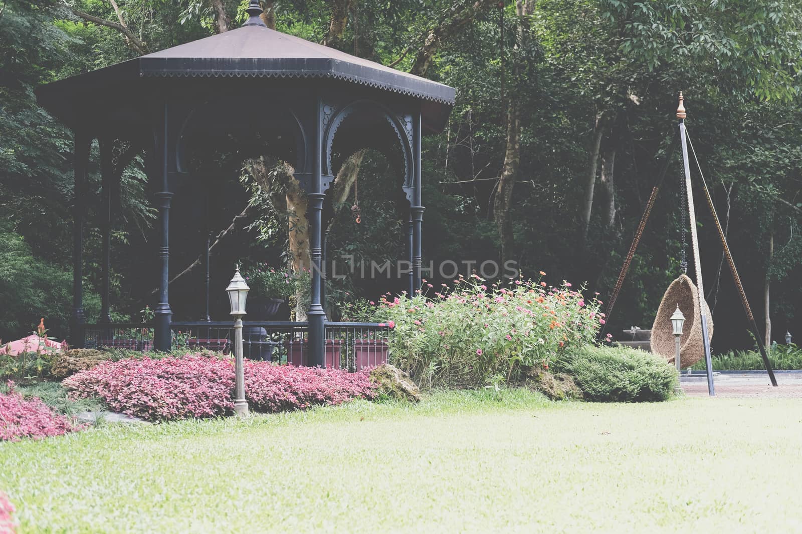 gazebo pavilion for resting in garden park. tranquil nature scene