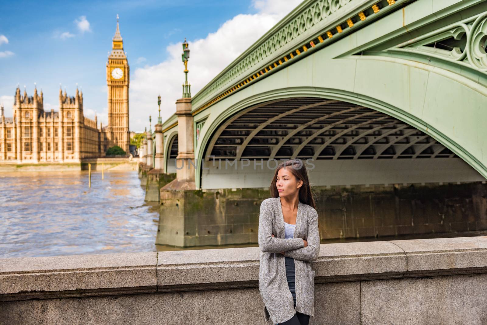 London city lifestyle casual young Asian woman relaxing by the Thames River by Big Ben, UK, Europe. by Maridav