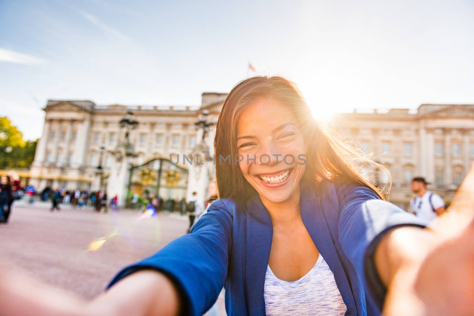 Travel selfie vlogger live streaming video online asian tourist woman social media influencer taking photo at Buckingham Palace London, UK. Europe summer vacation people lifestyle by Maridav