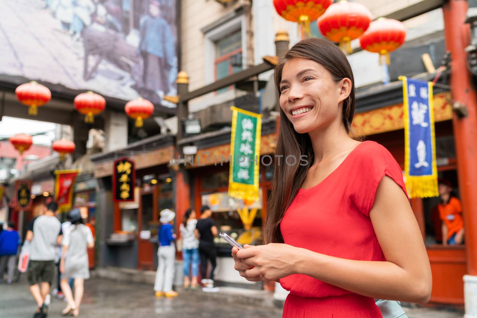 China food market tourist woman walking using phone on Beijing hutong street travel vacation adventure. City lifestyle young Asian girl. Asia summer travel destination. Girl traveling Asia chinatown by Maridav