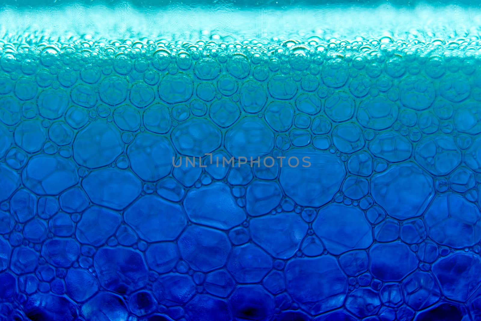 Abstract macro clean blue foam shot background of soap bubbles with light and color reflections effects by robbyfontanesi