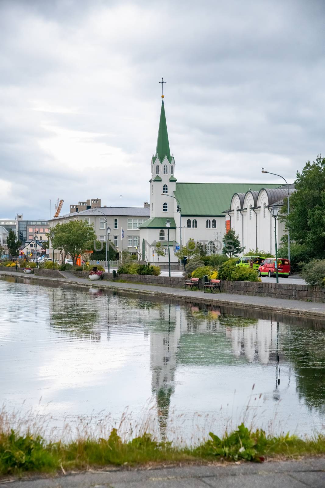 REYKJAVIK, ICELAND - AUGUST 11, 2019: Lake Tjornin with church on a cloudy summer day.
