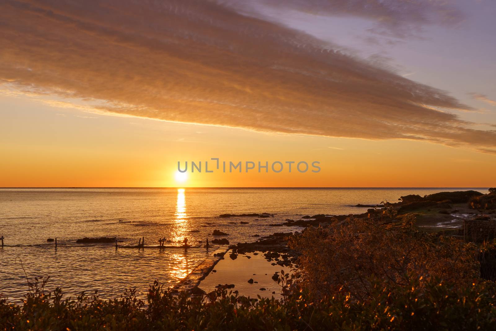 Orange sky with gorgeous cloud on an old sea pier in dawn or sunset