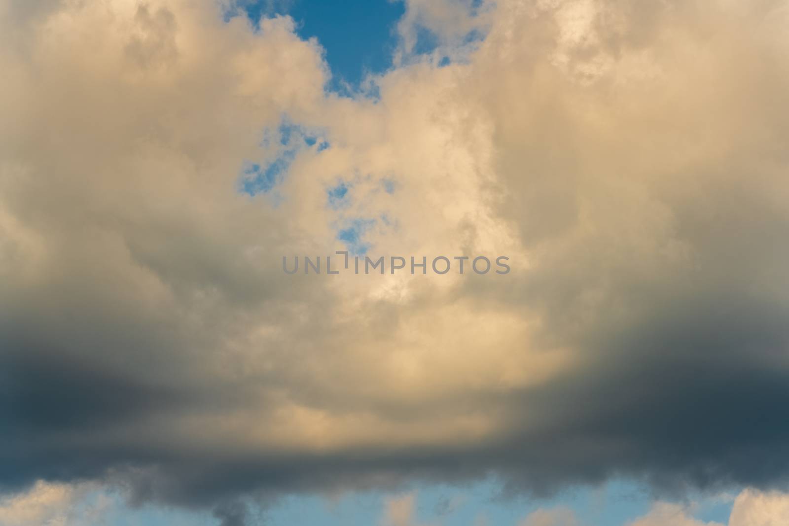 Beautiful summer natural meteorology background: stunning cloudscape, dramatic clouds floating across blue sky to weather change before rain. Atmospheric dispersion, motion blur clouds and soft focus.