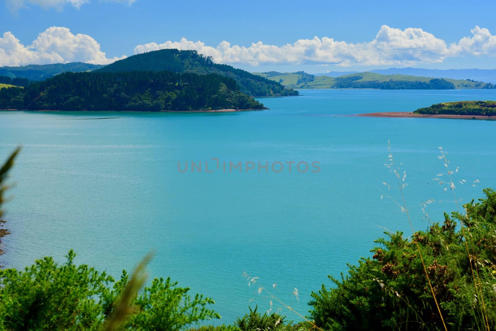 Beautiful seascape of New Zealand; ocean and shore; a small island far away