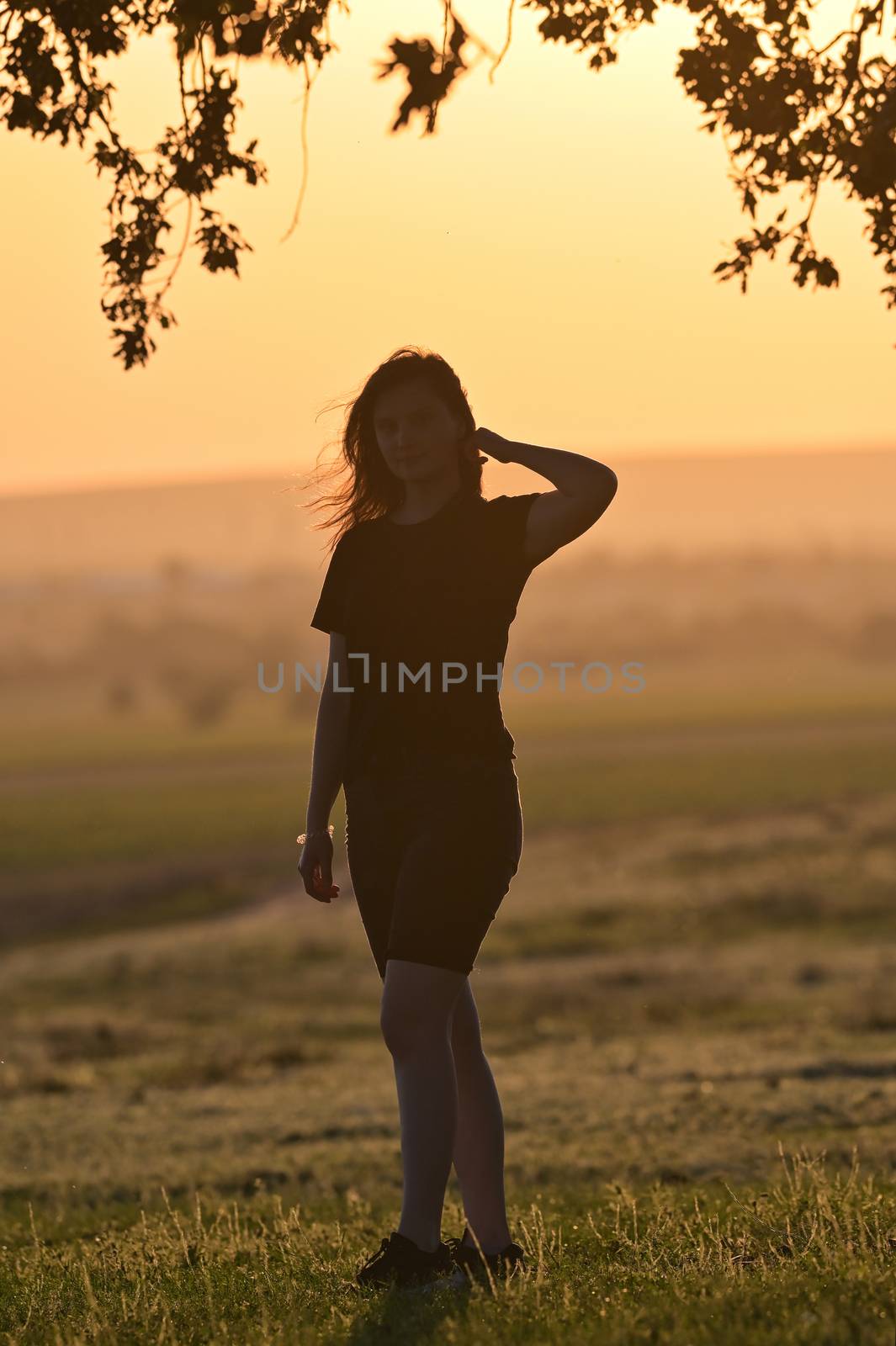 Portrait of young woman silhouette at sunset