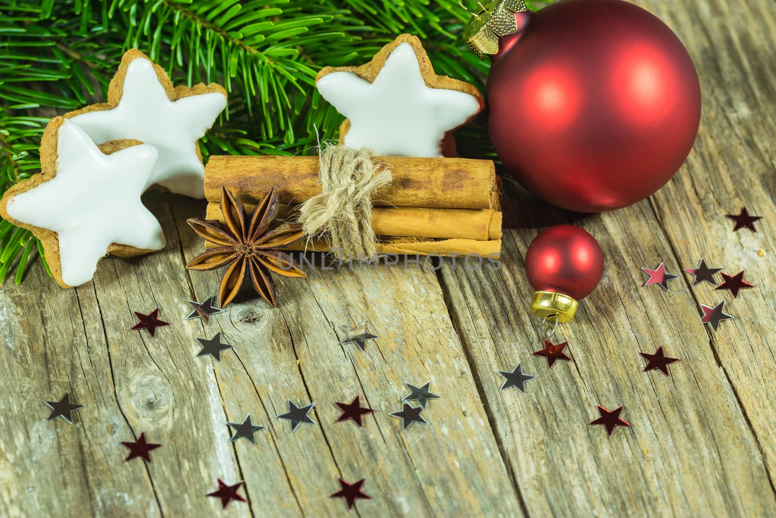 Christmas holiday star shaped gingerbread cookies with ornaments on wooden background 