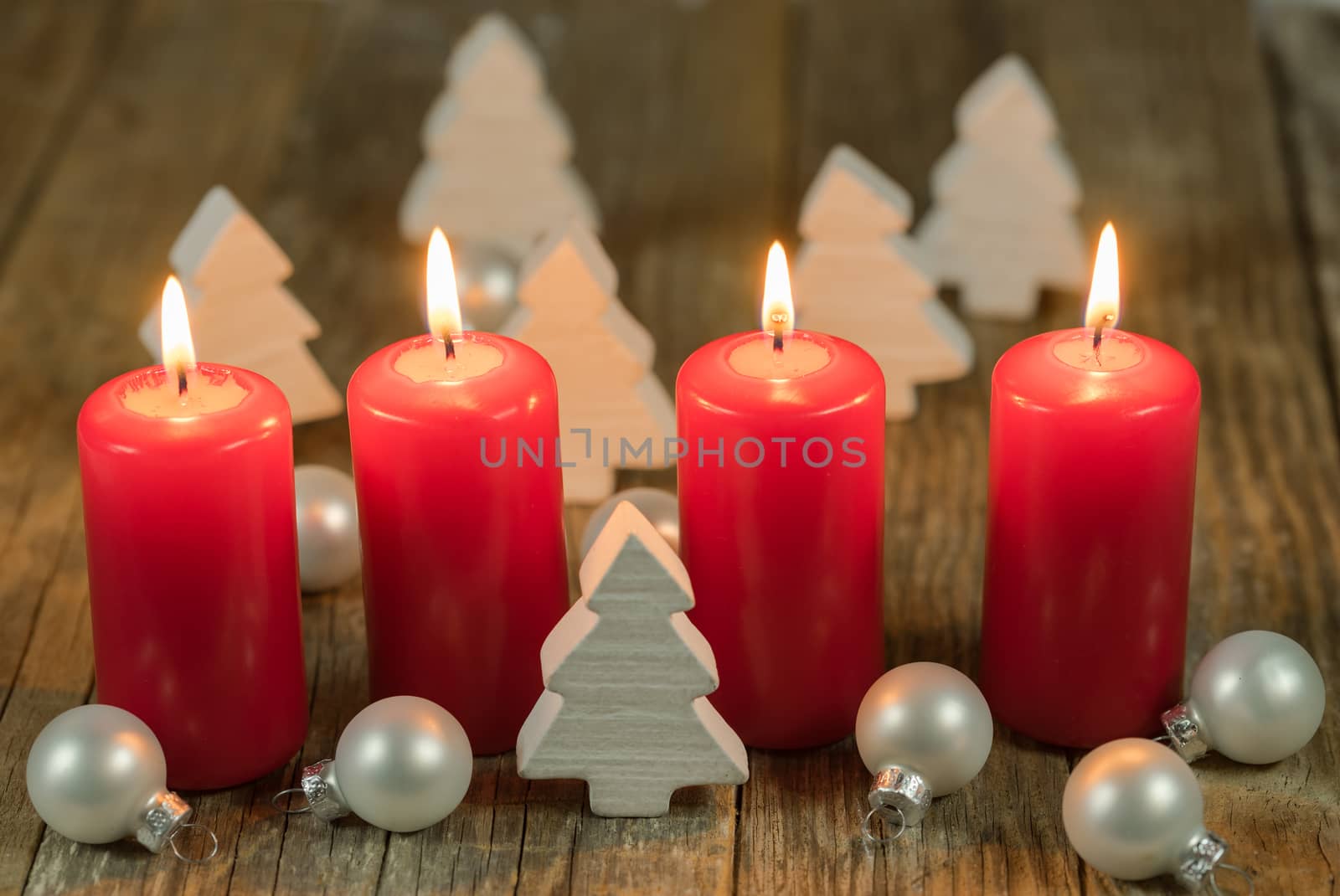 Merry Christmas decoration advent with burning red candles and white ornaments