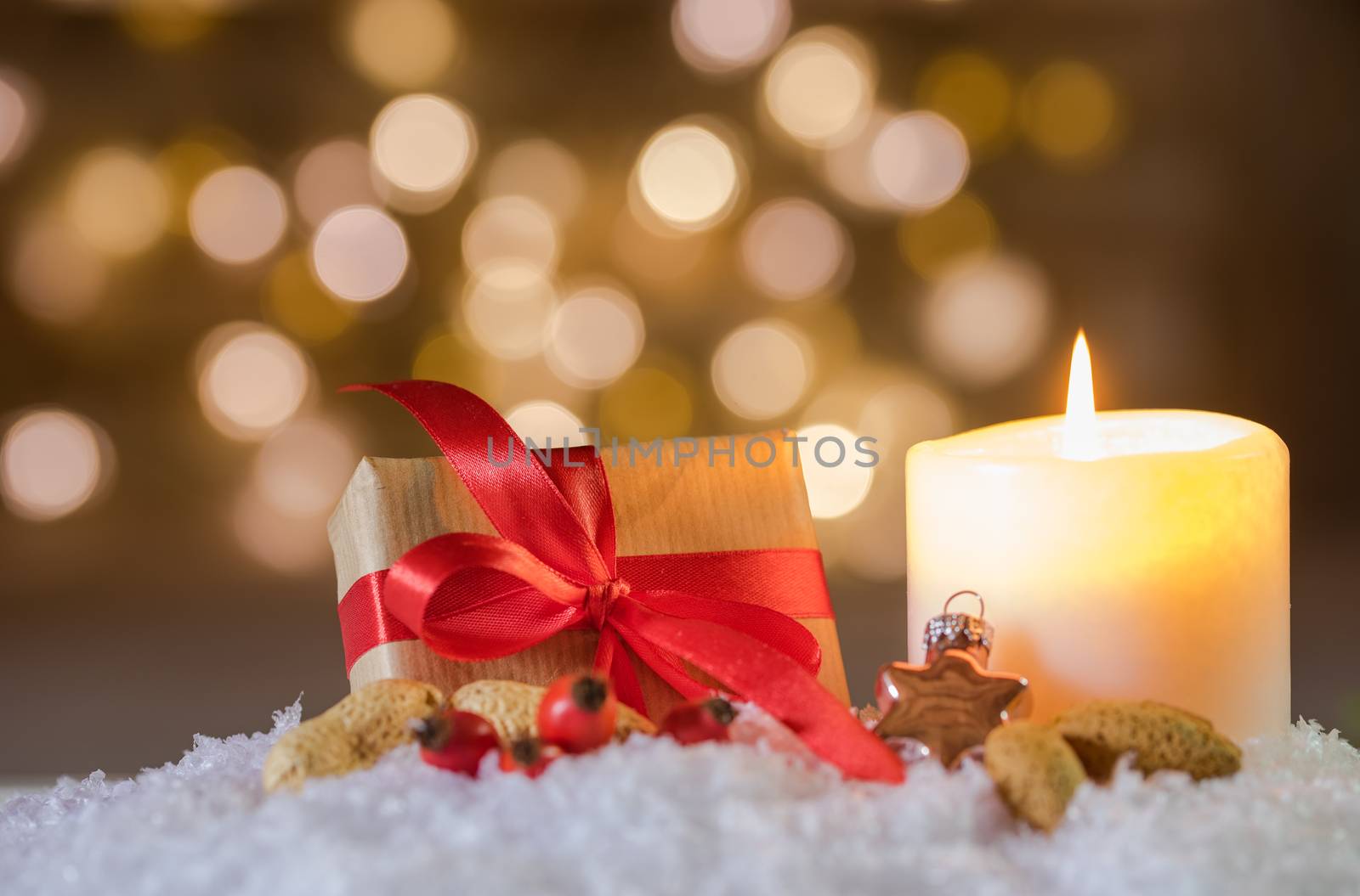 Advent and Christmas present with candlelight on snow 