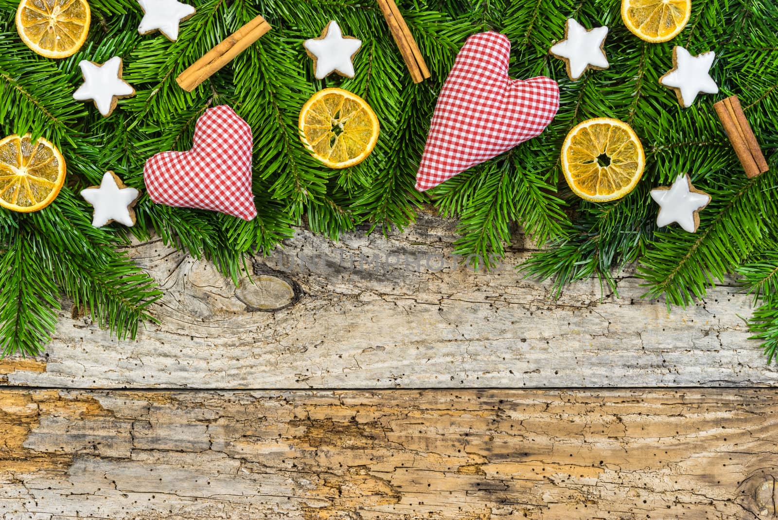 Christmas hearts with natural decoration on rustic wood background