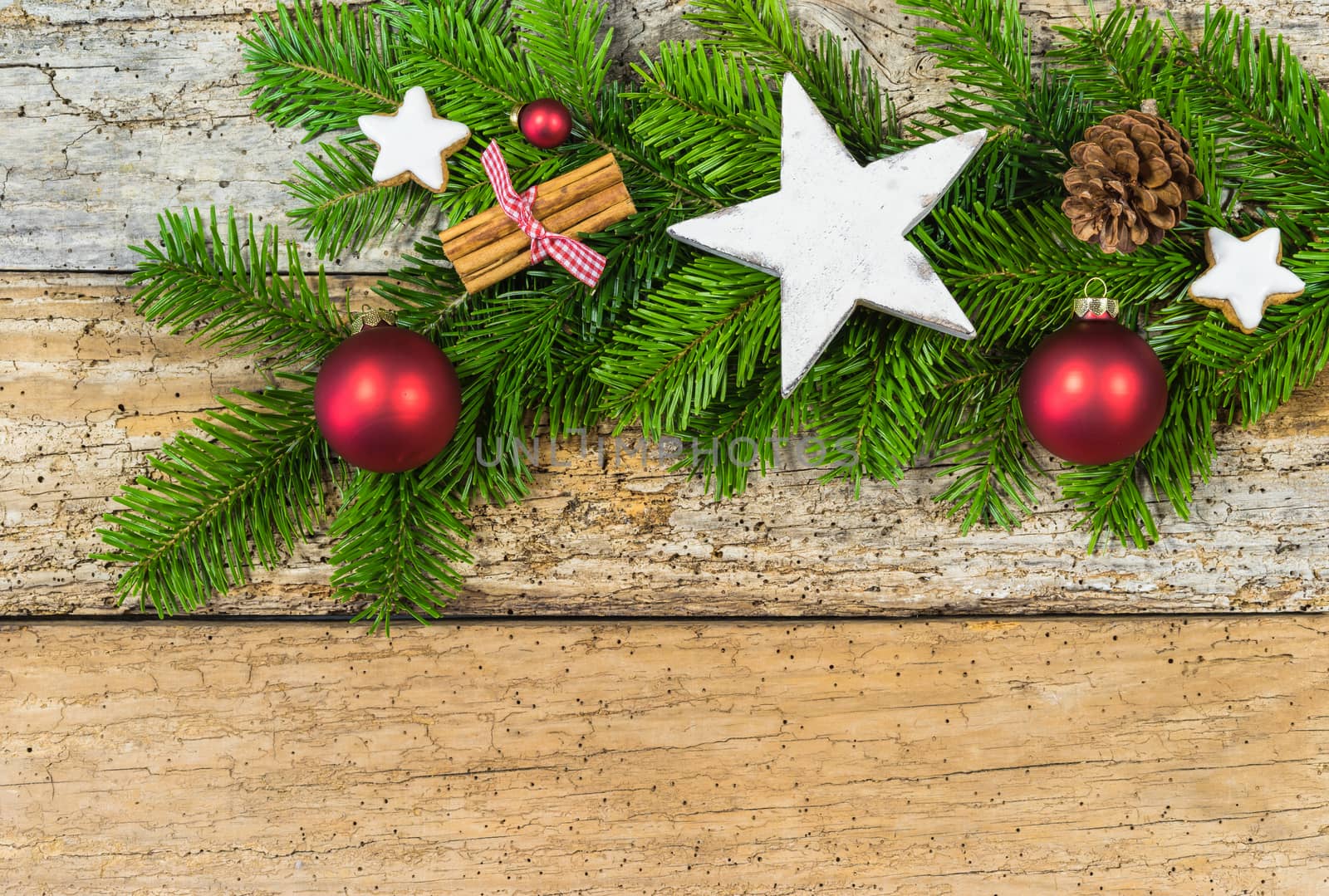 Natural Christmas decoration with fir branch and ornaments on wood