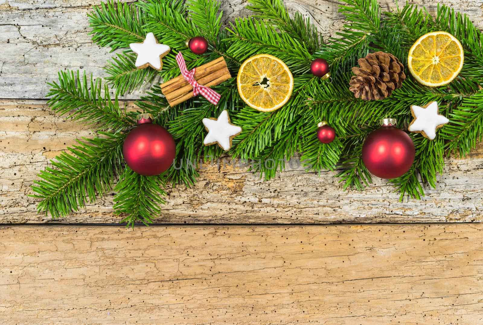 Christmas background with fir tree branch, natural decorations and ornaments on wood with copy space