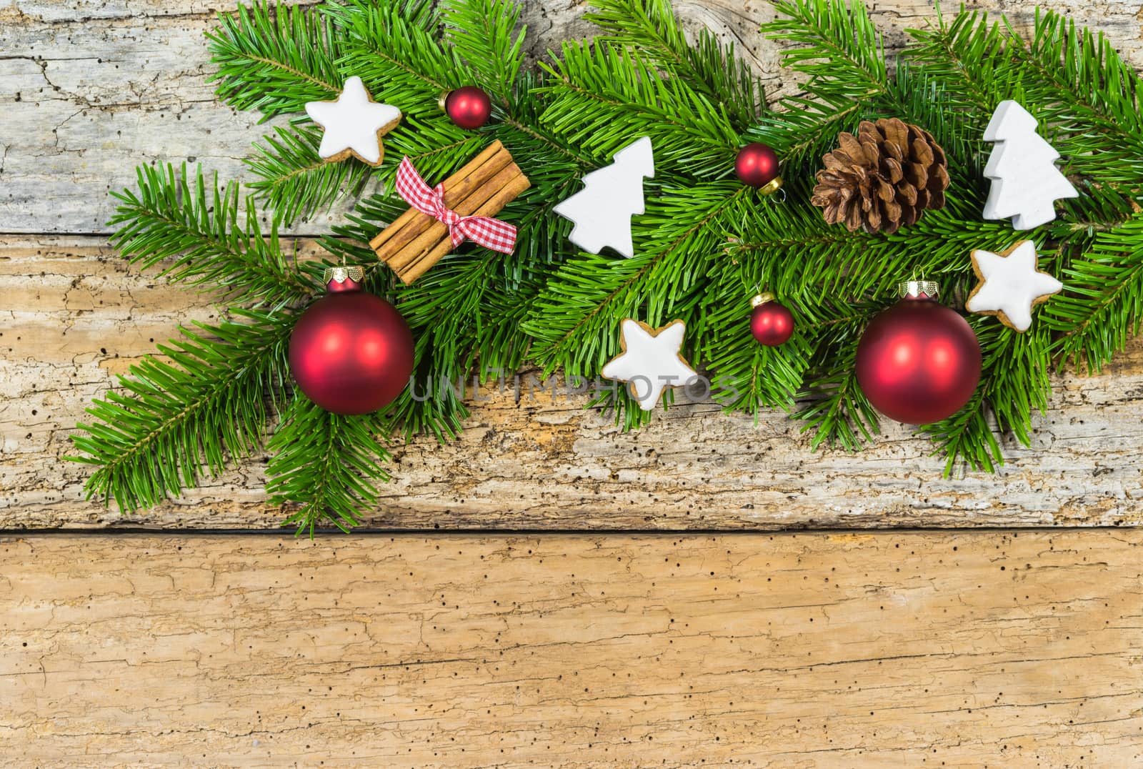 Rustic Christmas background with decorations and fir tree branch on wood, copy space