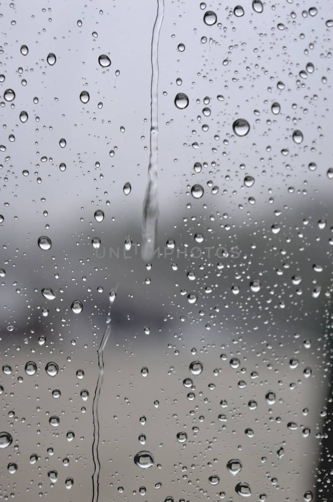 Drops of rain on the window, rainy day. Shallow DOF