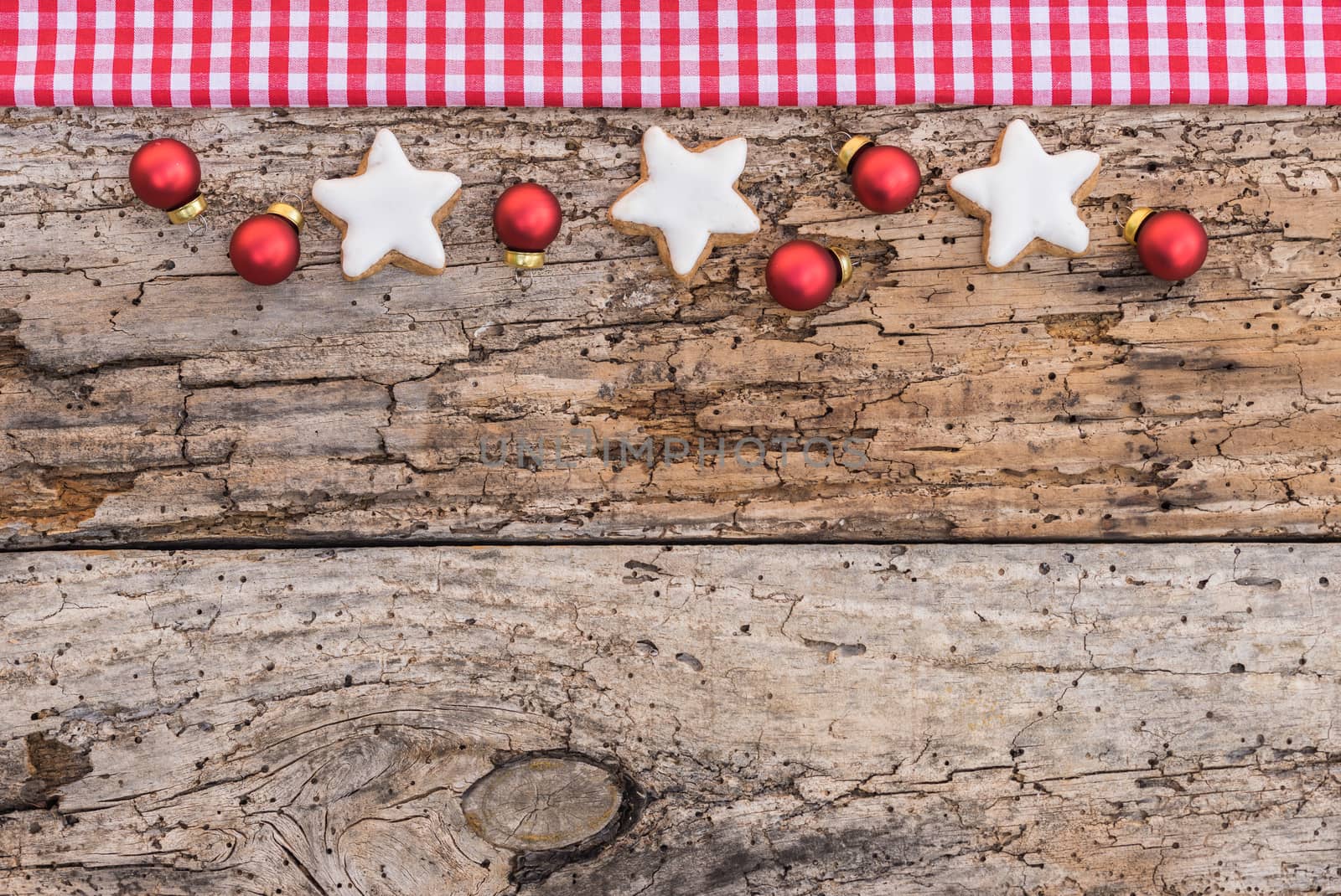 Christmas border with ornaments on rustic wood background, top view