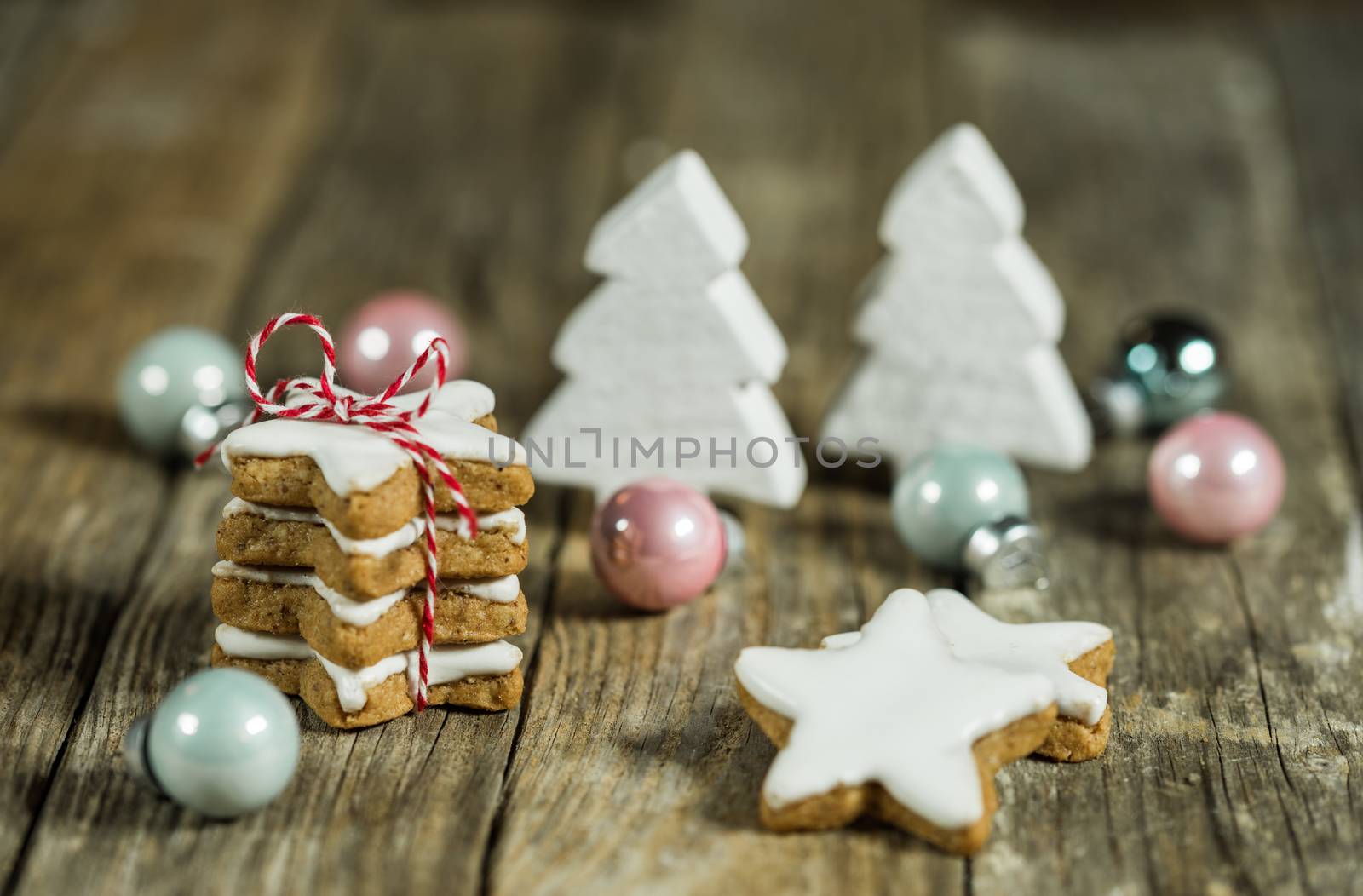 White and pastel colored christmas decoration with star cookies and ornaments