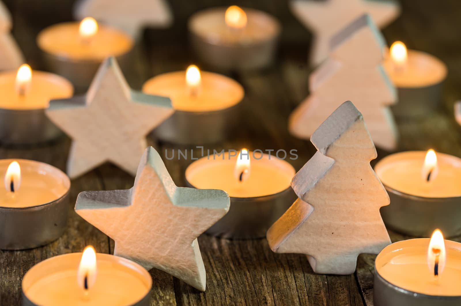 Christmas candles with white wooden christmas tree and star decorations