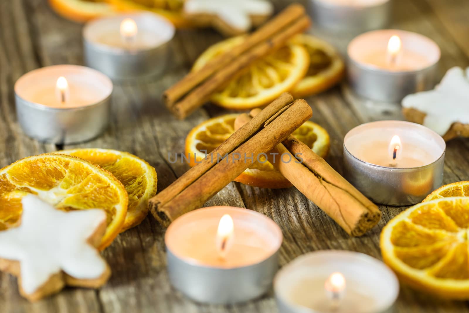 Christmas candles, cookies and spices decoration on wood