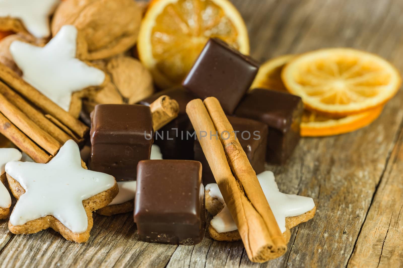 Advent and Christmas food, chocolates, star biscuits, cinnamon, nuts and orange slices