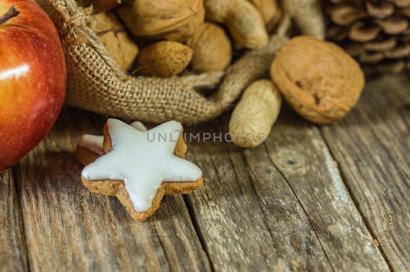 Christmas food on table, nuts, apple and star shape biscuit