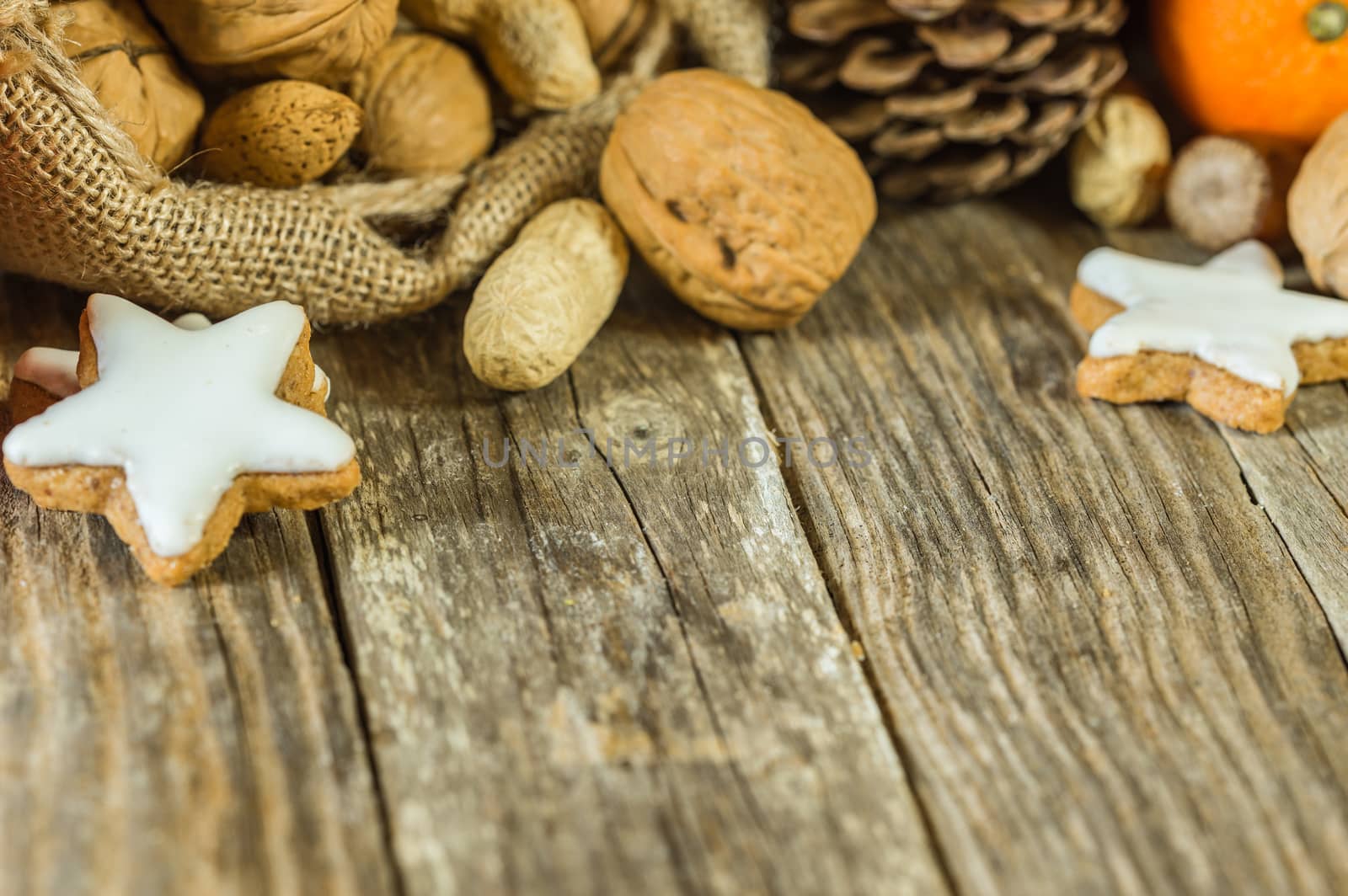 Advent and Christmas food, nuts and star shape cookie on table with text space