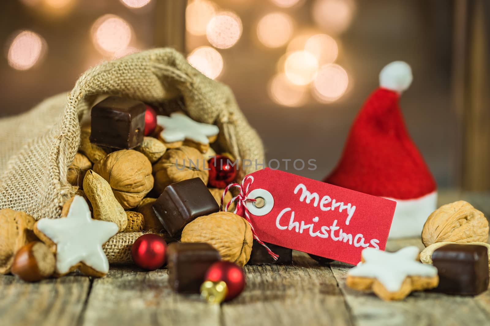 Christmas food and sweets with red santa hat and with tag text Merry Christmas