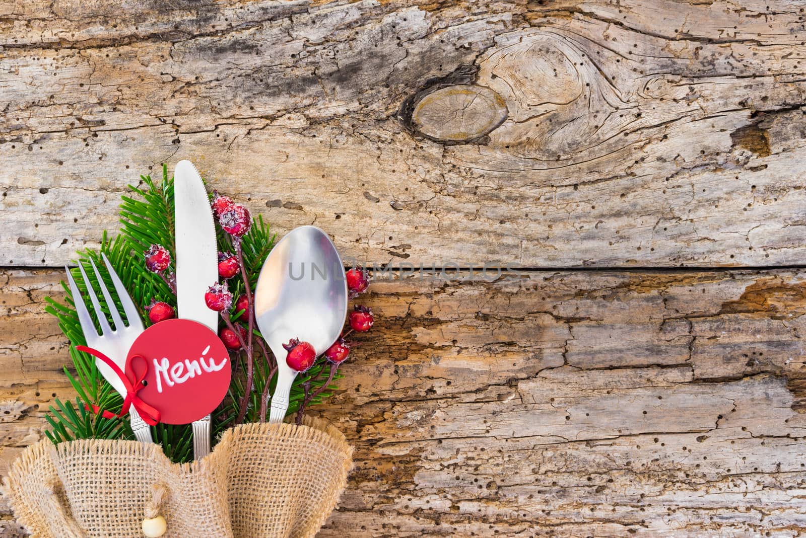 Christmas table place setting with tag and spanish word menú, means menu