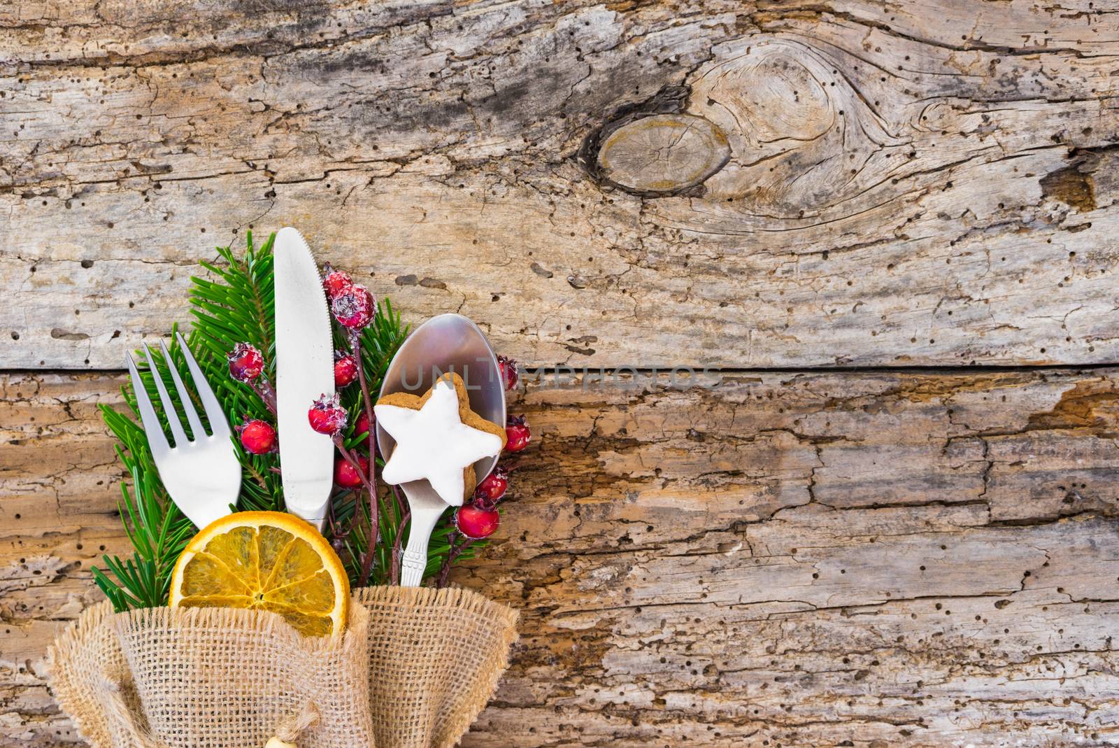 Advent or Christmas table setting with rustic silverware decoration 