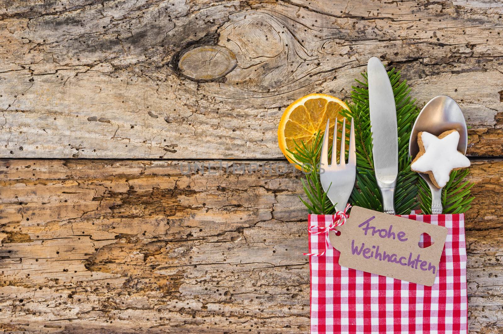 Christmas table place setting on rustic wooden background, copy space by Vulcano