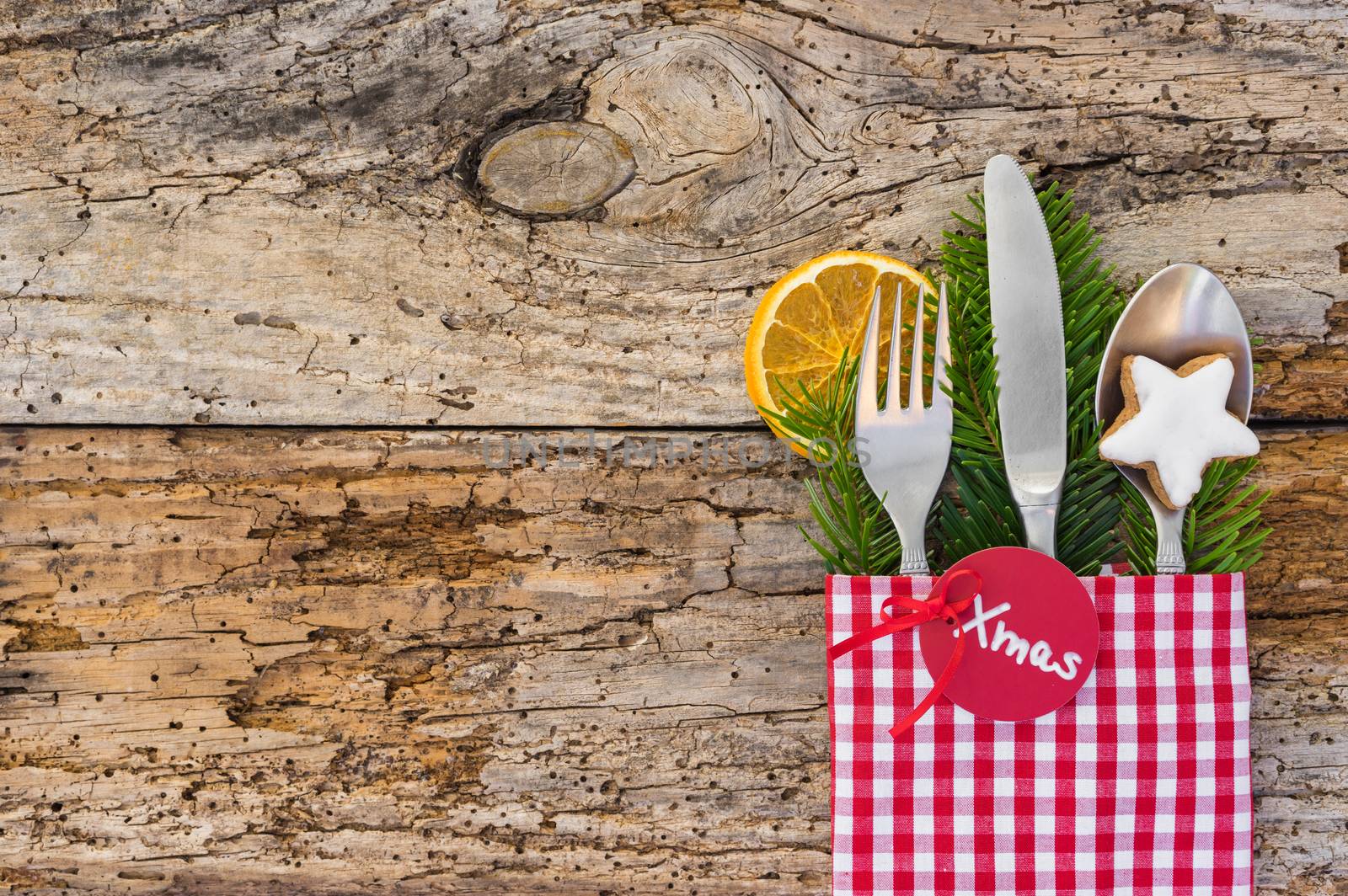 Christmas table place setting with napkin and rustic silverware by Vulcano