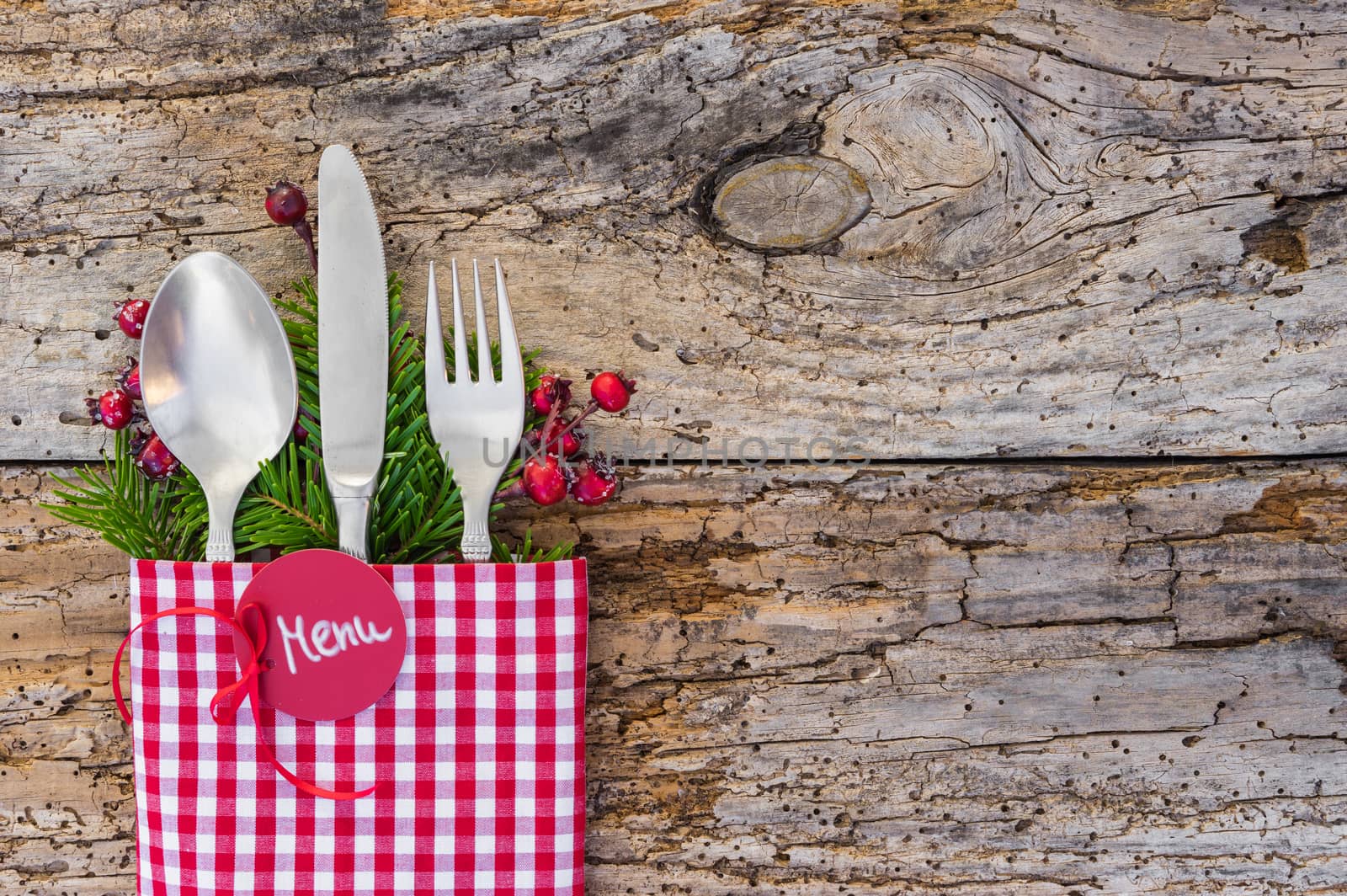 Christmas table place setting, rustic wooden background, copy space