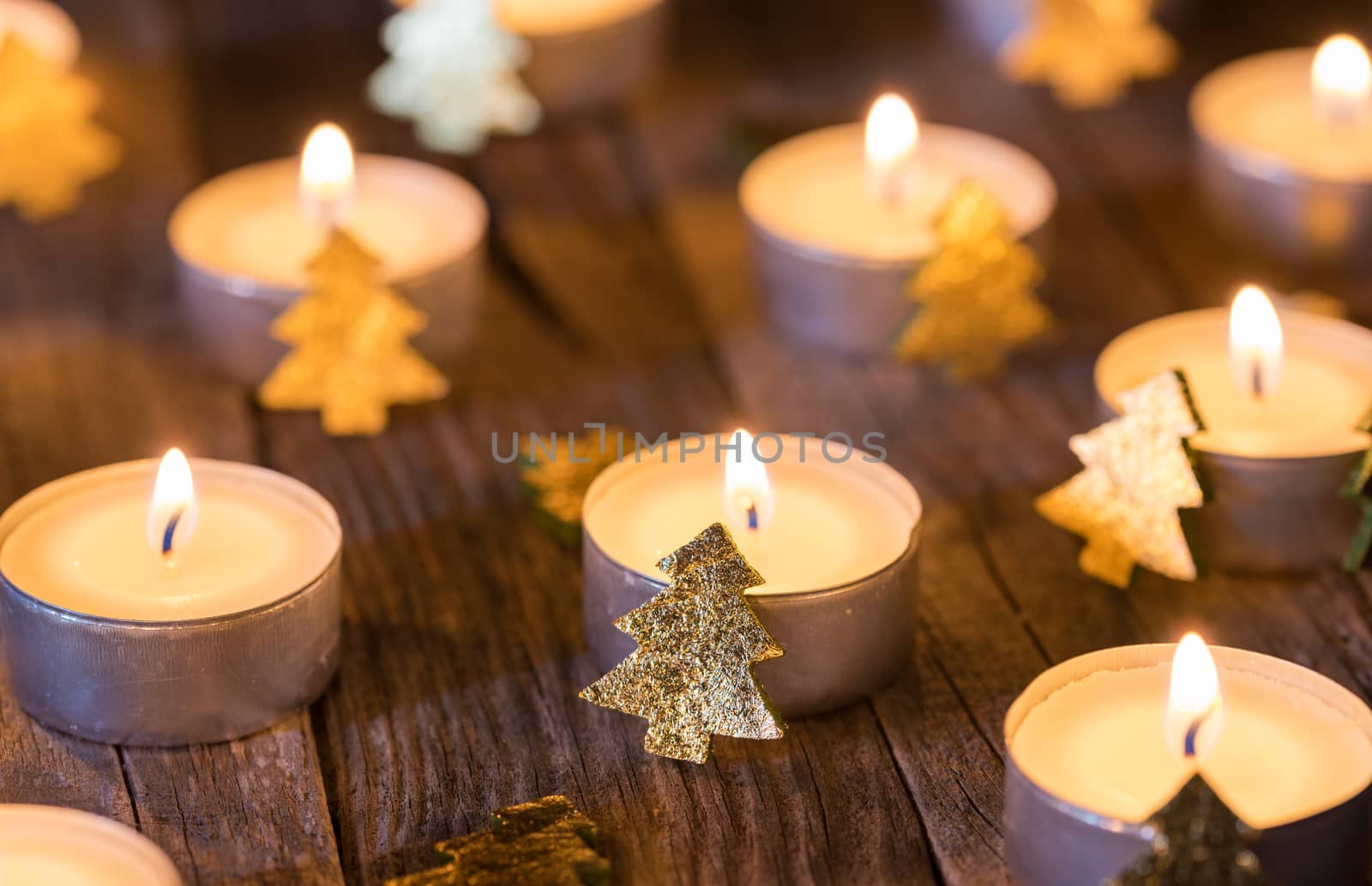Festive candlelight with christmas decoration on wooden table, close-up