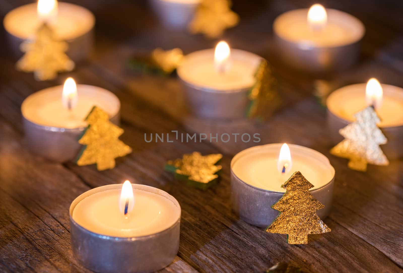 Festive candlelight with christmas decoration on wooden table, close-up by Vulcano