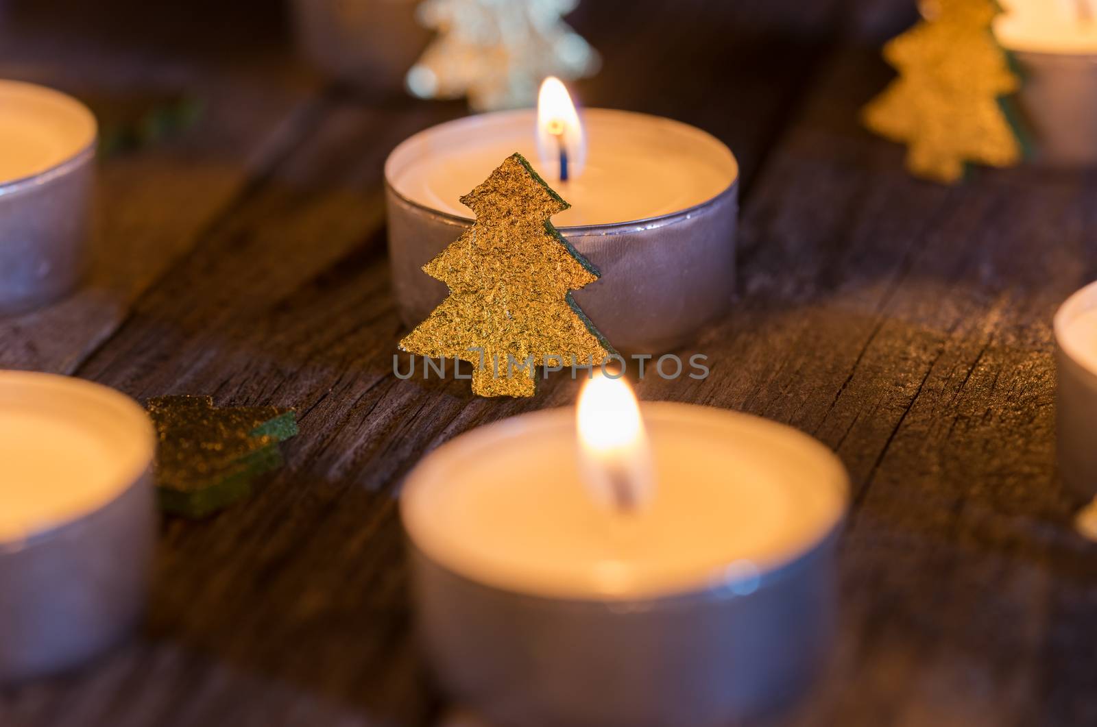 Advent or Christmas candlelight with ornaments on wood