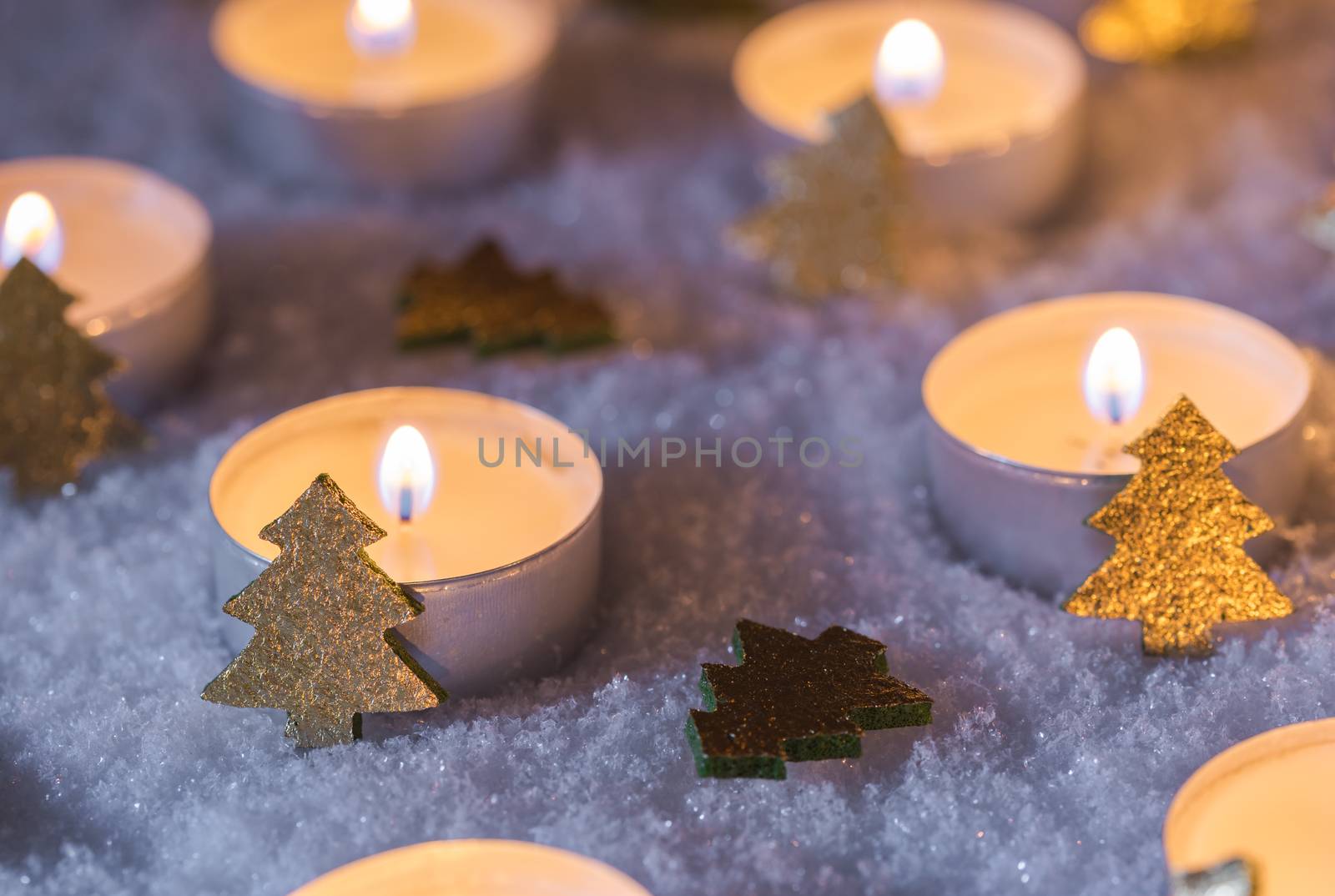 Christmas winter night with candle flames and ornaments on snow by Vulcano