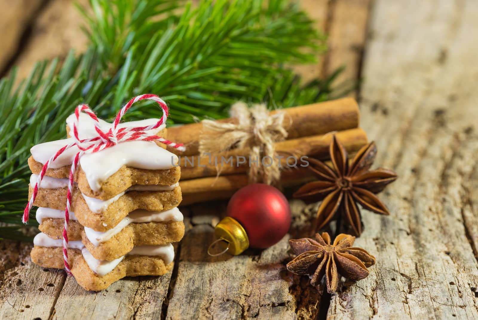 Christmas still life with star biscuit, spices and ornaments on wooden table by Vulcano