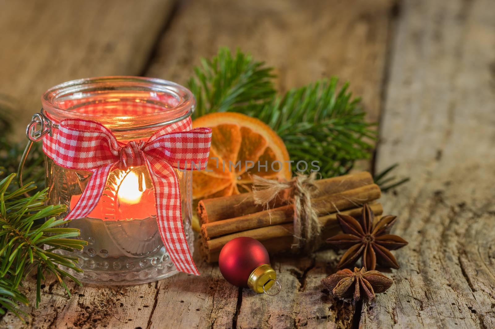 Rustic Christmas candle in lantern with ribbon and rustic decorations by Vulcano