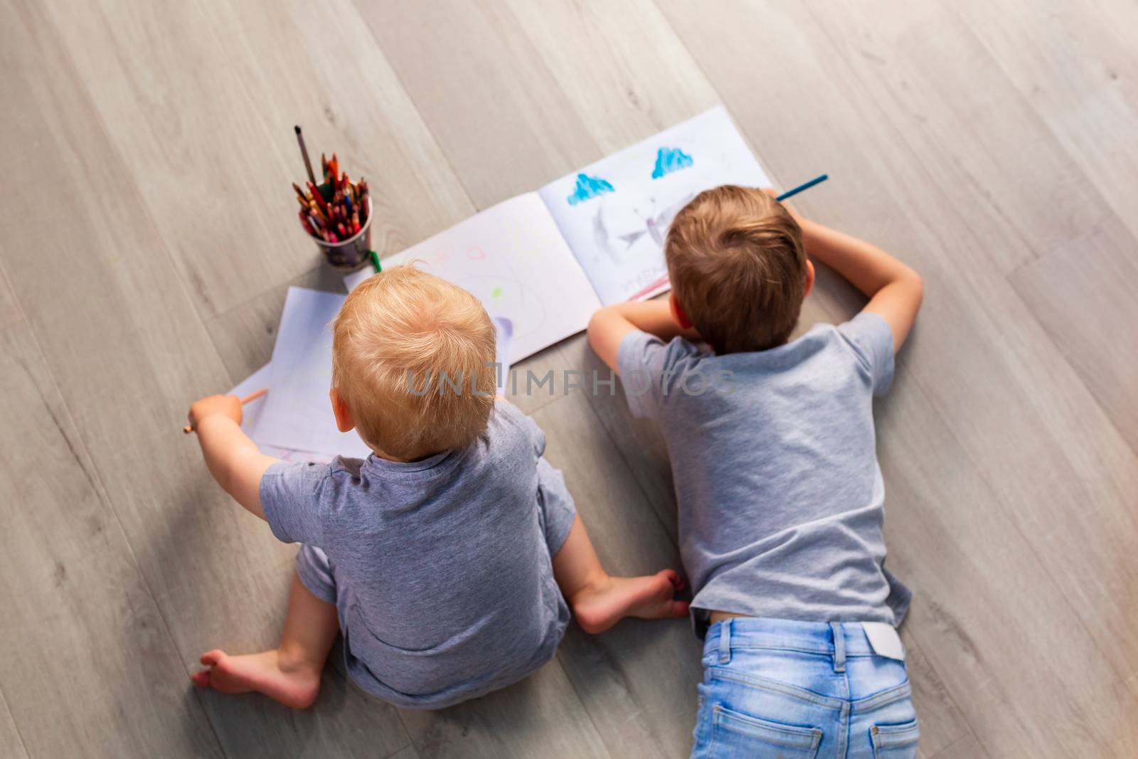 Two little boys drawing on the floor in his room by Len44ik
